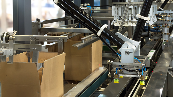 A carton former prepares boxes for shipment after online sales.